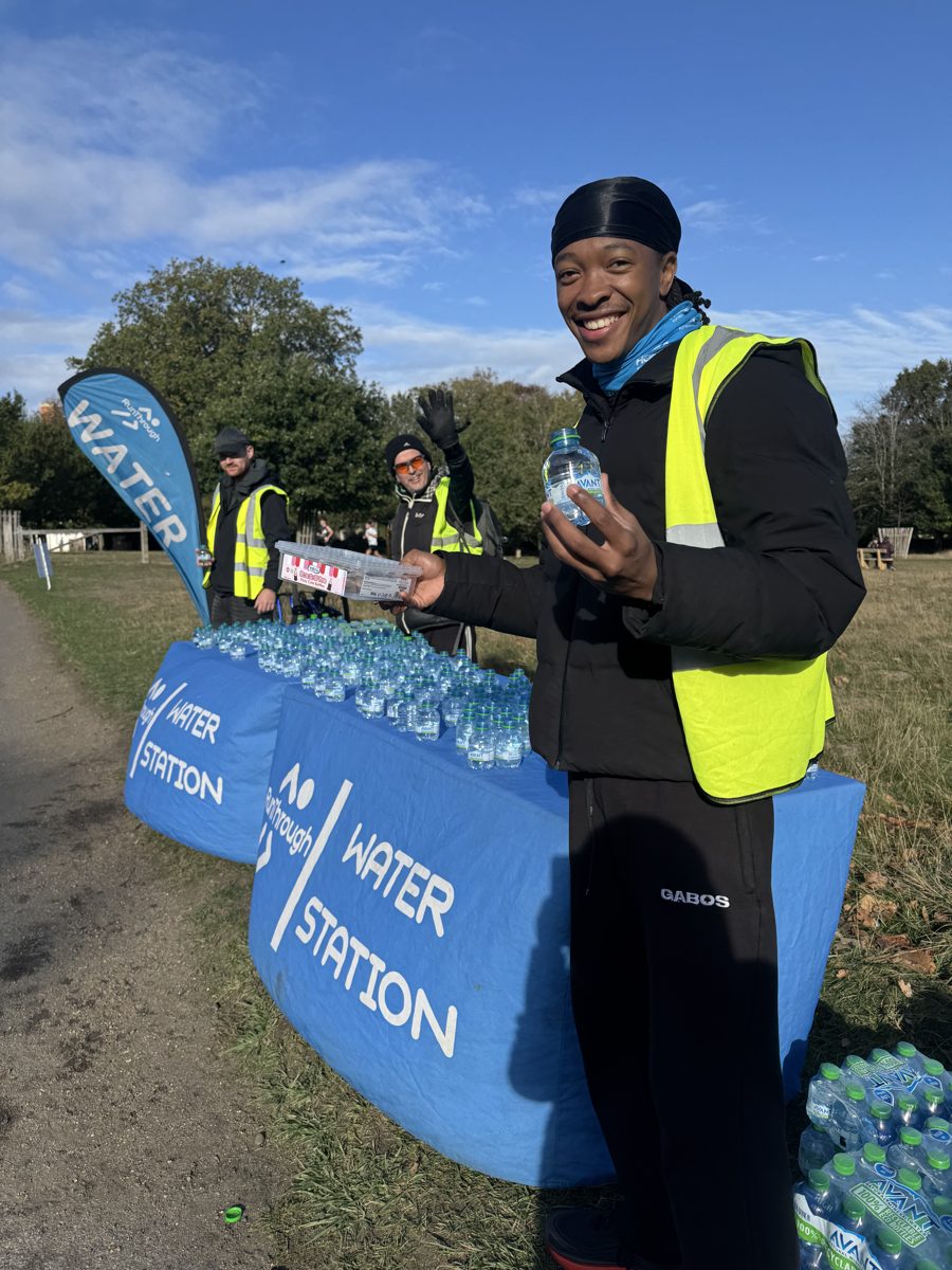 Tyrese in a hi-vis vest at a race water station
